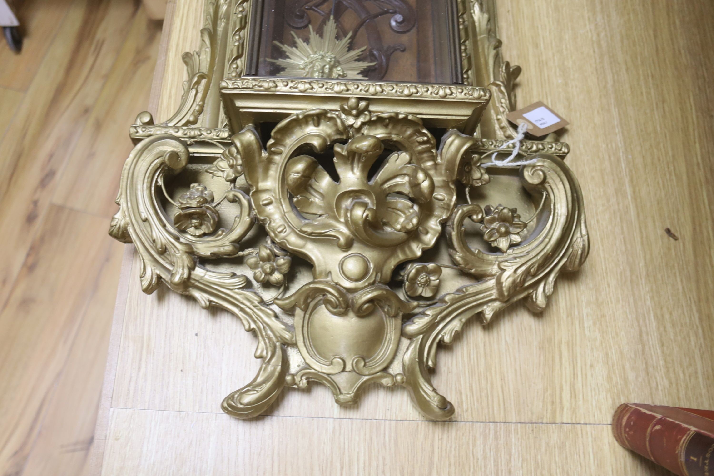 A 19th century French gilt and composition wall clock, with scrolled acanthus carving and 'sunburst' pendulum, 72cm high